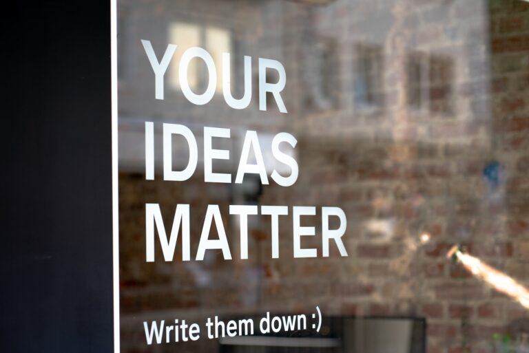 sign on glass door stating "Your Ideas Matter"